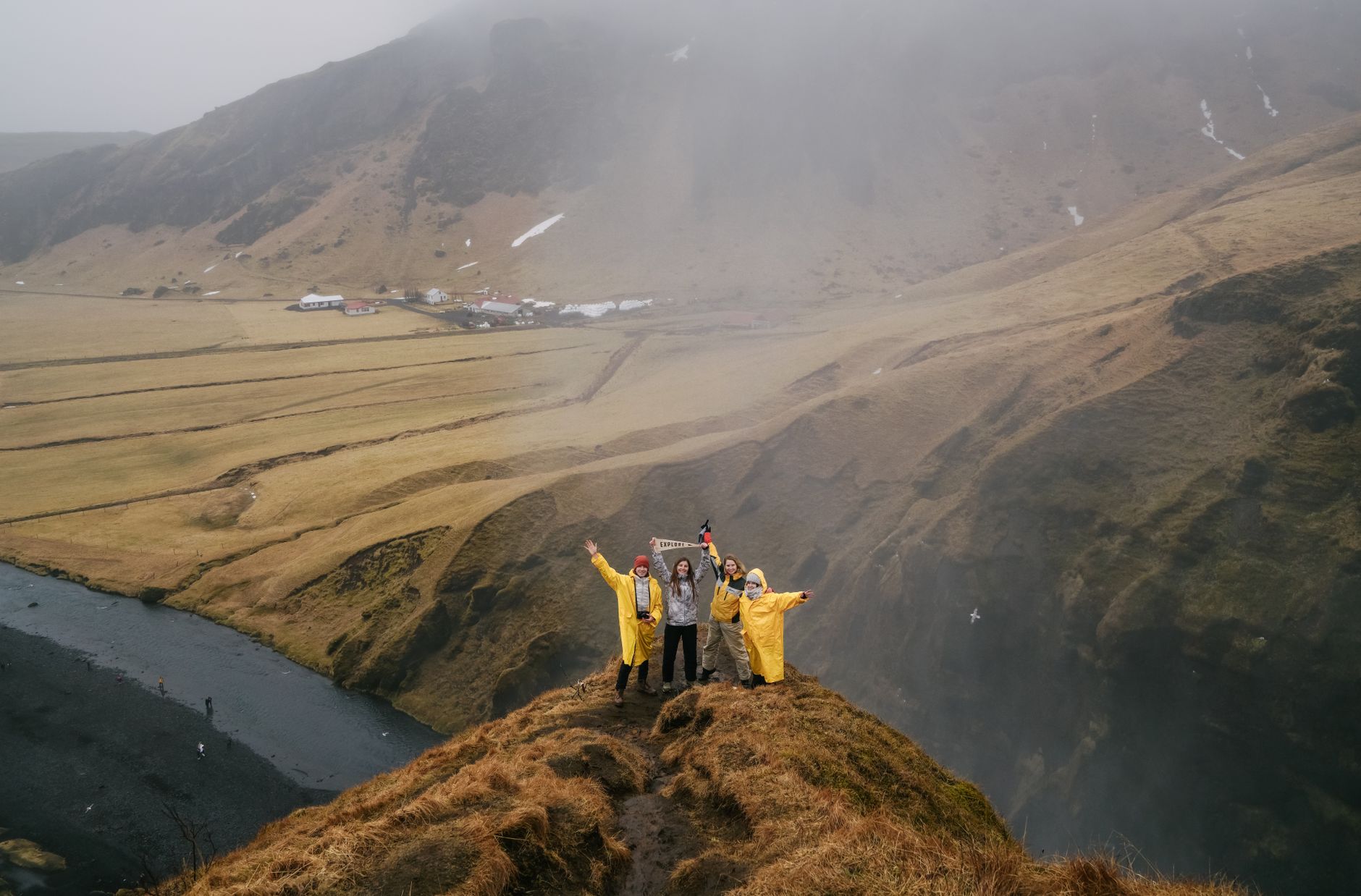 Hikers looking out at misty valley in New Zealand